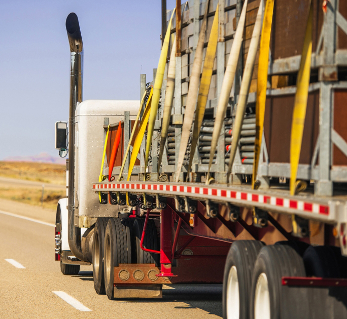 Buchanan Hauling & Rigging CDL-A flatbed company driver transporting secured freight.