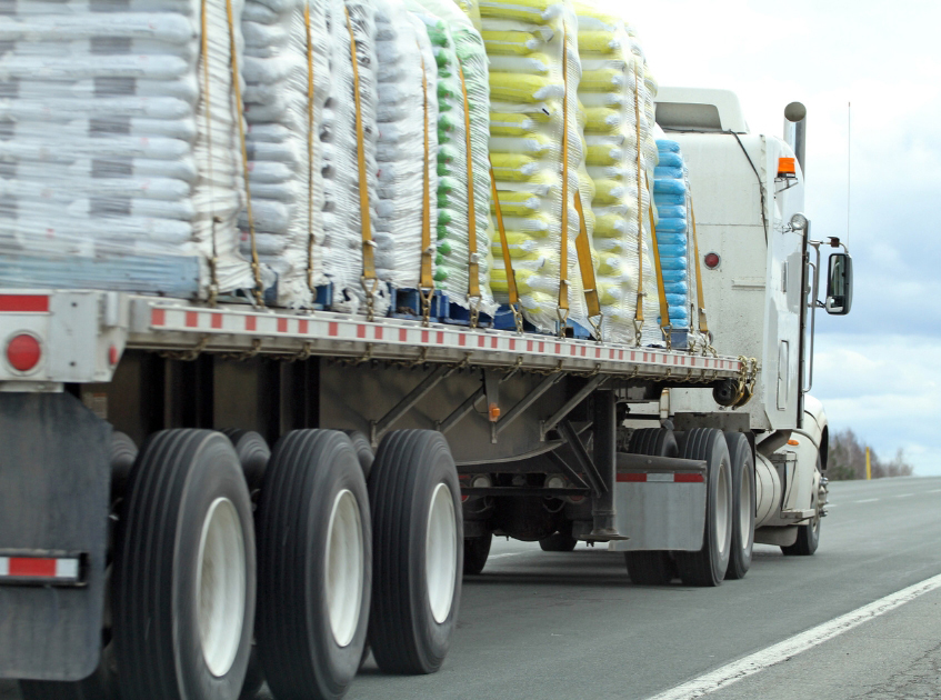 Buchanan Hauling & Rigging flatbed company driver hauling specialized freight with secured cargo.