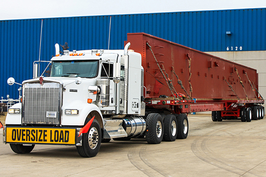 CDL-A heavy haul driver transporting an oversize load on a specialized trailer