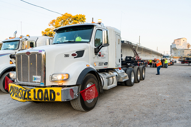 A heavy haul driver transporting an oversize load on a specialized trailer