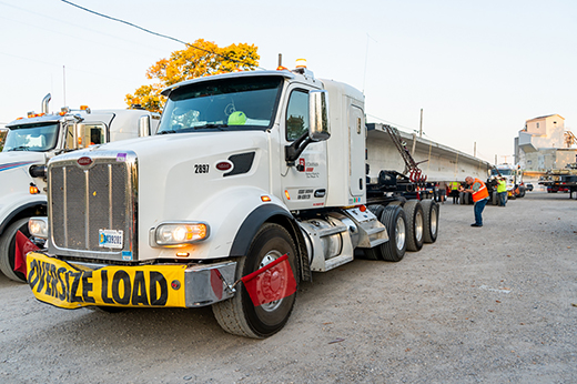 A heavy haul driver transporting an oversize load on a specialized trailer