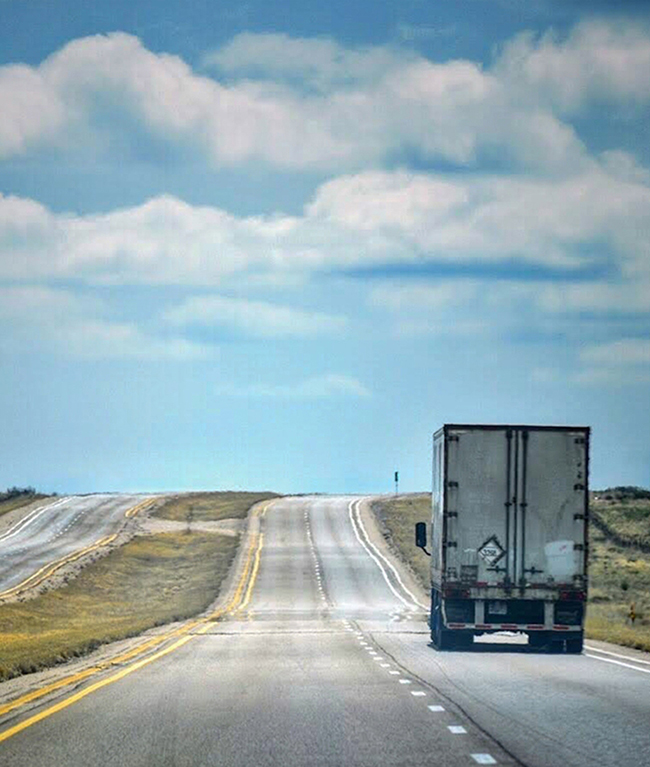 Experienced CDL-A truck driver hauling freight on interstate highway