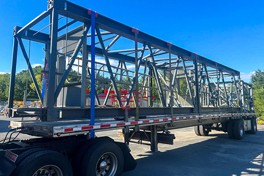 Truck hauling oversized freight with high value load