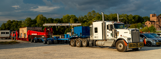 Heavy haul semi truck transporting industrial equipment on highway
