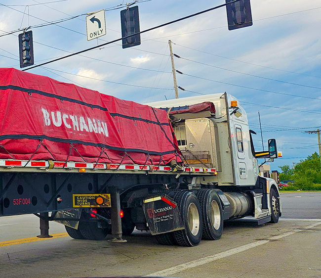 CDL-A driver comparing flatbed and dry van freight options for long-term trucking stability