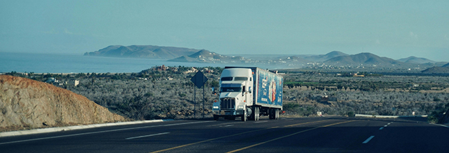 CDL-A truck traveling regional highway route during freight delivery
