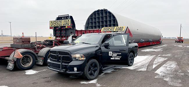 CDL-A driver hauling oversized load with escort vehicles