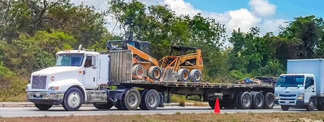 Flatbed truck hauling secured construction materials